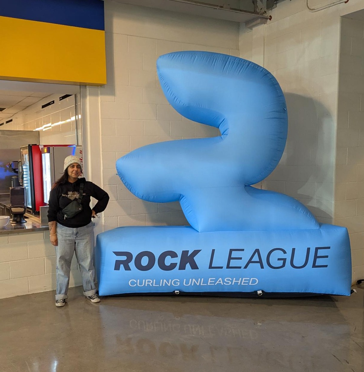 Me standing in front of a giant inflatable Rock League logo