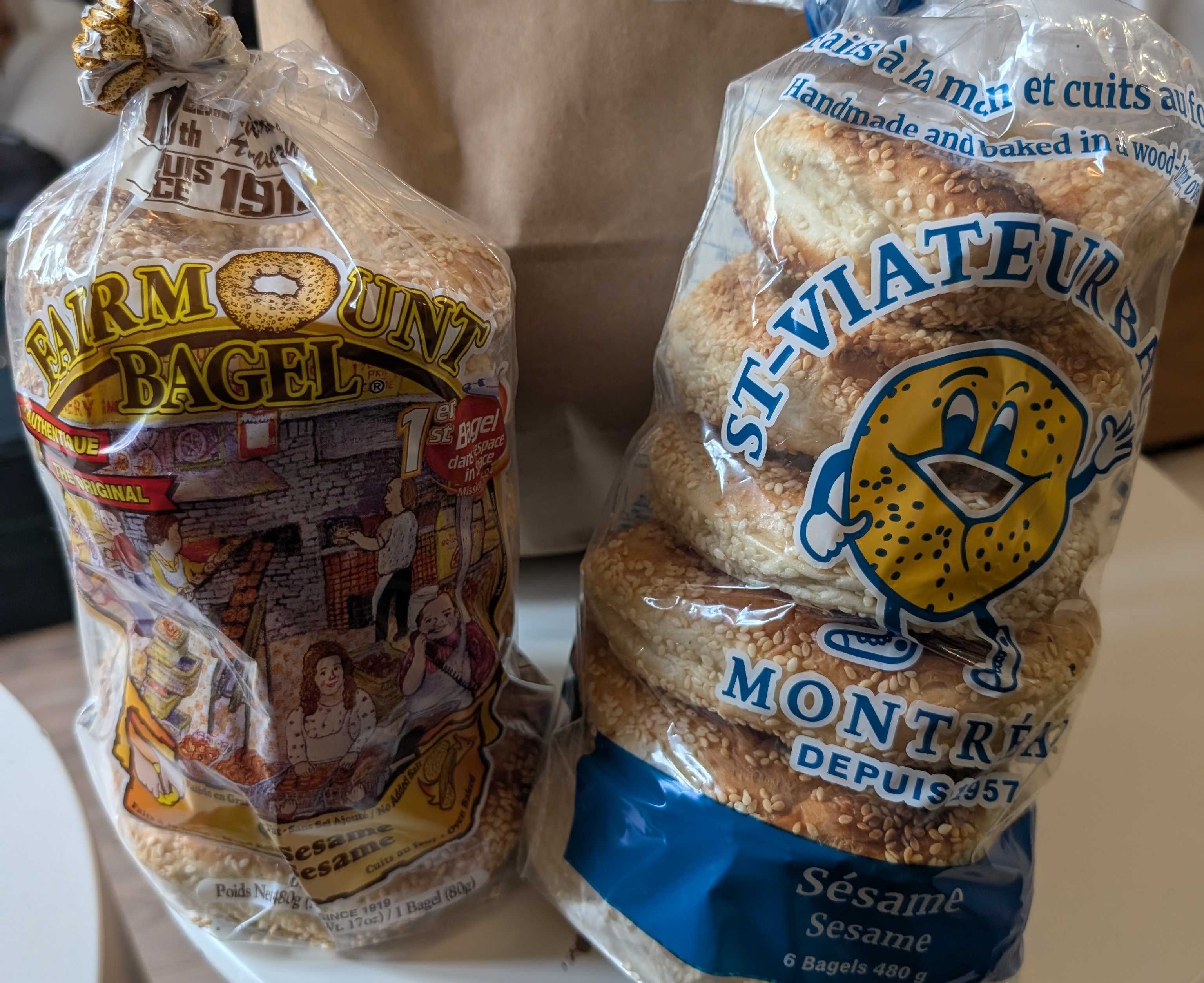 Two sleeves of bagels, one from Fairmount and one from St-Viateur