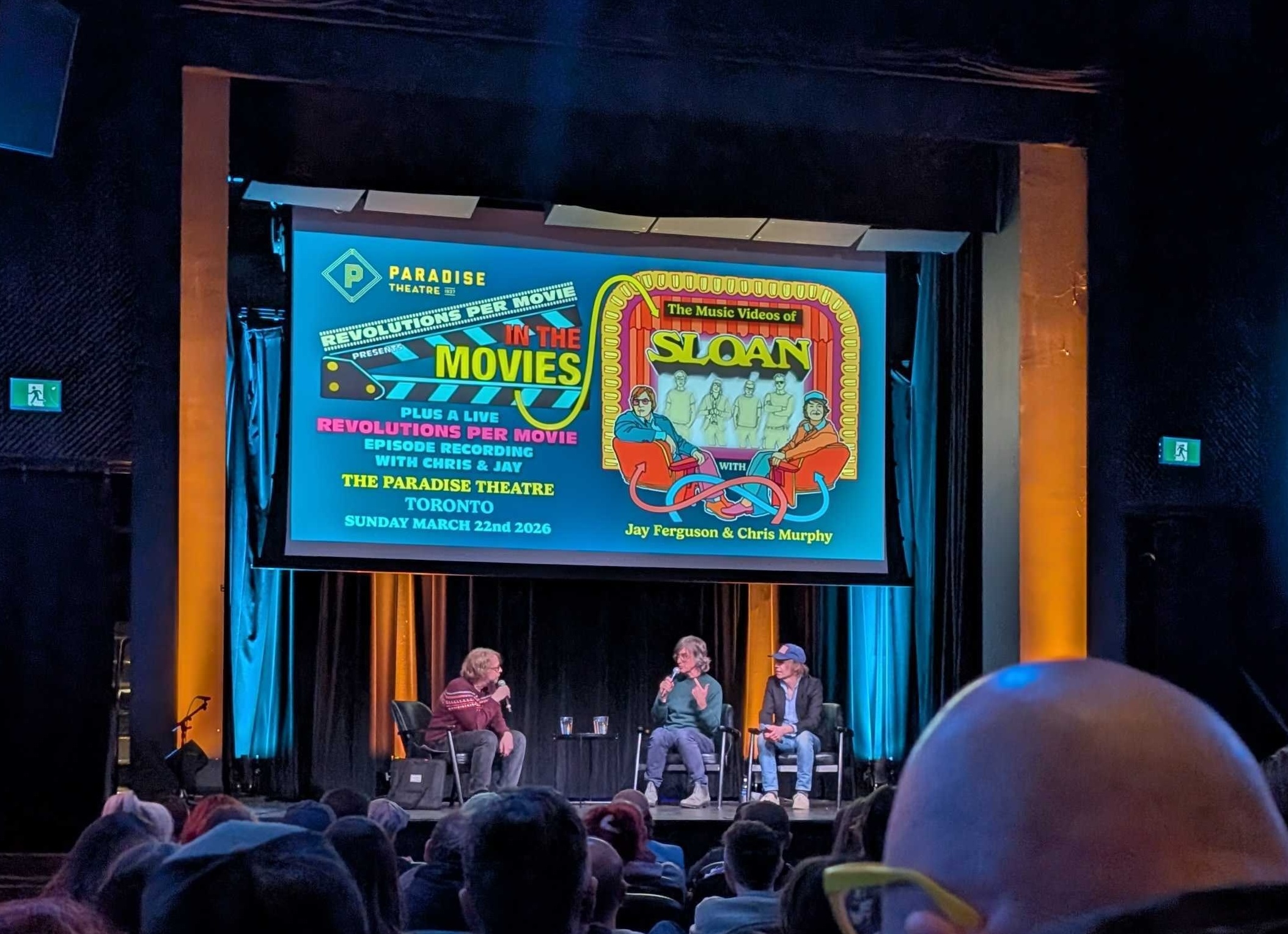 Chris Murphy and Jay Ferguson of Sloan being interviewed on stage by Chris Slusarenko