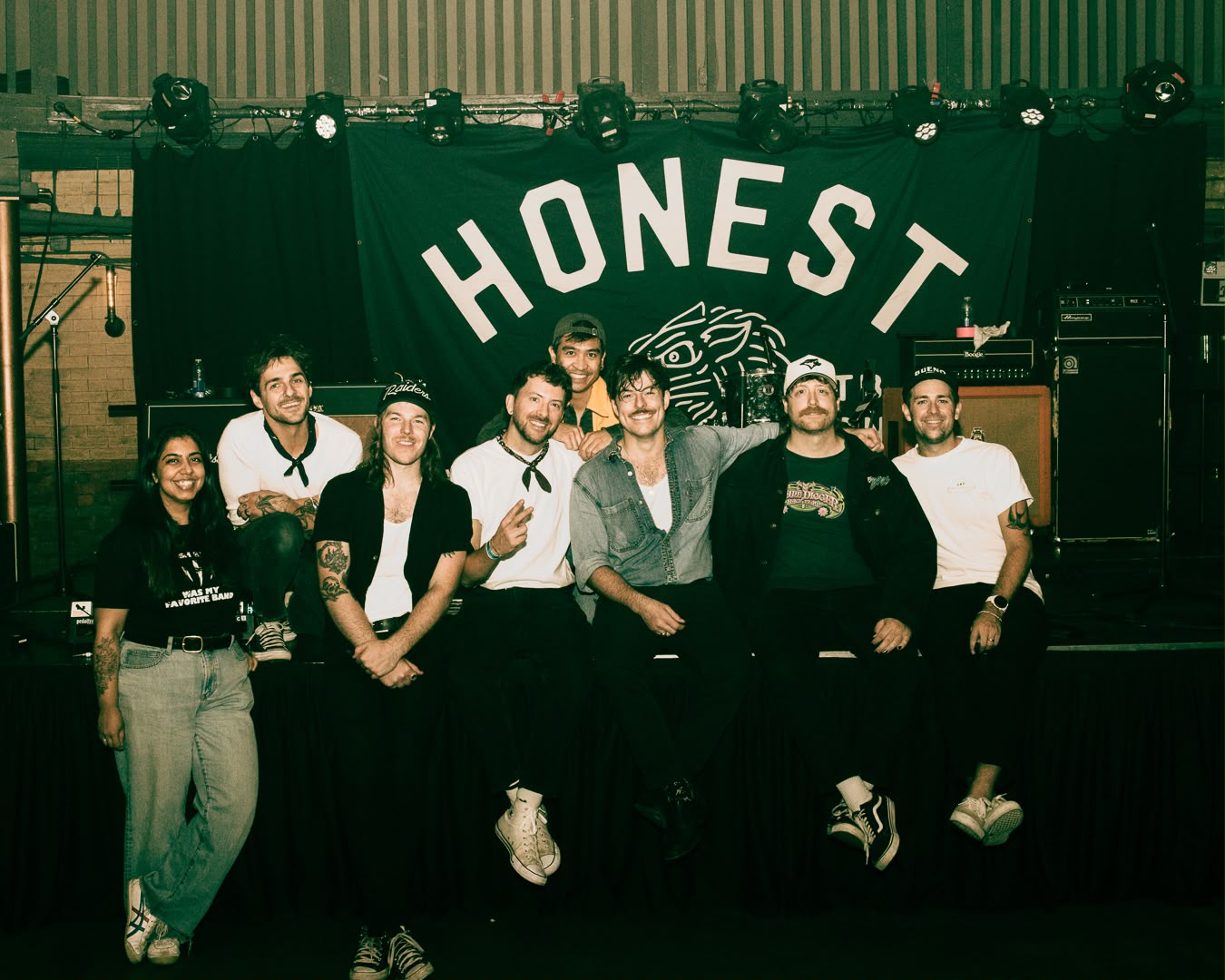 A group shot of Survival Club and the Honest Heart Collective on the stage at Longboat Hall